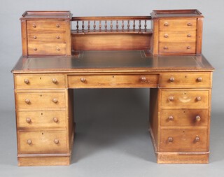 A Victorian style bleached mahogany Dickens style desk, the upper section fitted a shelf with bobbin turned decoration flanked by 6 short drawers, having a green inset writing surface, the base fitted 1 long drawer above pedestals fitted 8 short drawers 110cm h x 153cm w x 79cm d 