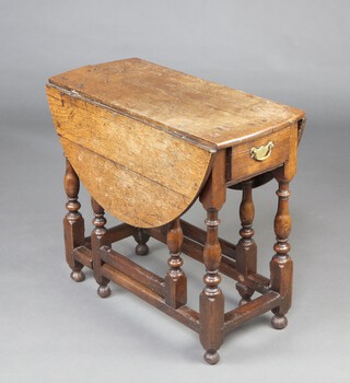 An 18th Century light oak drop flap gateleg tea table, fitted a frieze drawer, raised on turned supports 68cm h x 66cm w x 33cm when closed x 96cm when open 