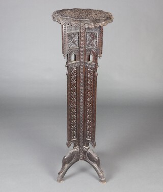 A Victorian carved and pierced Anglo Indian torchere with shaped top and pierced panels to the sides, raised on elephant supports 121cm h x 38cm diam. 