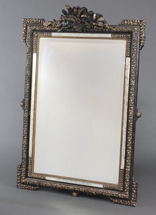 A 19th Century Continental rectangular bevelled plate mirror, contained in a black and gilt painted plaster frame surmounted by a basket of flowers 129cm h x 90cm w 