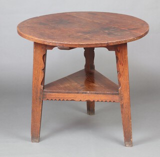 An 18th Century elm and pine circular cricket table, the top formed of 3 planks, raised on outswept supports with undertier 75cm h x 84cm diam. 