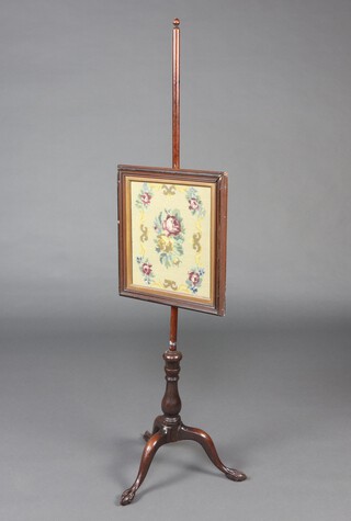 A 19th Century pole screen with rectangular mahogany Berlin wool work panel, raised on a pillar and tripod base with egg and claw feet 135cm h 