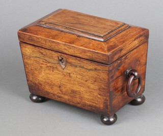 A 19th Century mahogany sarcophagus shaped tea caddy with hinged lid, ring drop handles to the sides, raised on bun feet 14cm h x 19cm w x 12cm d 