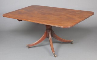 A Georgian mahogany rectangular breakfast table, raised on a turned column and tripod base with brass caps and casters 69cm h x 153cm w x 102cm d 