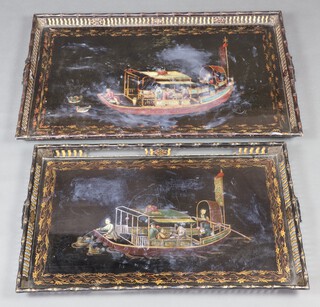 Two Regency style black lacquered trays decorated boats 90cm x 57cm and 80cm x 49cm 