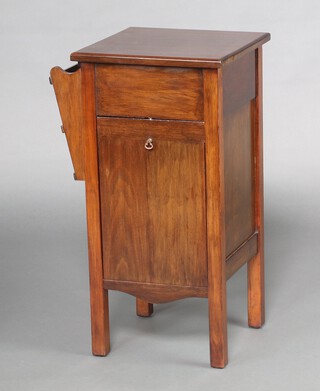 Papworth Institute Cambridge, a 1930's cabinet with hinged lid, the back fitted a shelf, the front with fall front, cupboard and newspaper rack to the side, raised on square tapered supports 77cm h x 38cm w x 37cm d 