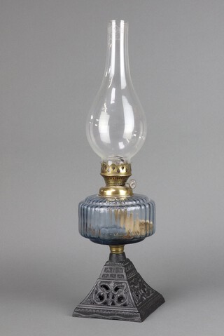 A Victorian reeded blue glass oil lamp reservoir, raised on a pierced waisted square base complete with chimney 52cm h 