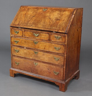 A Georgian walnut and crossbanded bureau, the fall front revealing a stepped interior with cupboard, pigeon holes and drawers, above 3 short and 3 long drawers, raised on bracket feet 104cm h x 88cm w x 51cm d 