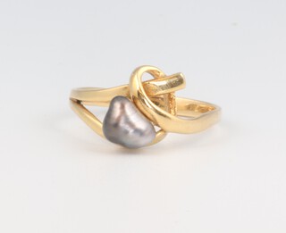 A yellow metal 750 baroque black pearl ring, size P, 3.1 grams 