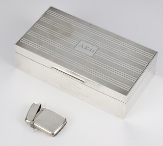 A silver engine turned rectangular cigarette box with engraved monogram London 1945, 16.5cm and a silver vesta with engraved monogram Birmingham 1912 