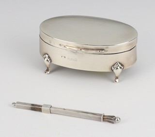 An Edwardian oval silver trinket box Birmingham 1911 8cm and a ditto swizzle stick