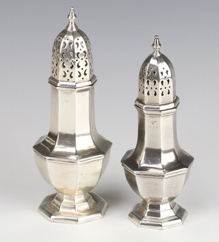 A Queen Anne style octagonal silver sugar shaker, London 1969, 17cm, a ditto rubbed marks 19cm, 268 grams 