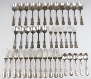 A quantity of Sterling silver cutlery with fancy handles, comprising 12 table spoons, 6 dessert spoons, 5 tea spoons, 6 dessert forks and  12 dinner forks, 2155 grams, all engraved monogram A  