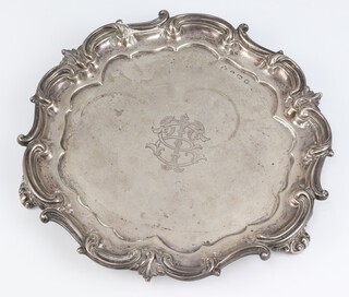 An Edwardian silver salver with scroll rim and engraved monogram on scroll feet, Birmingham 1905, maker Elkington and Co., 622 grams, 26cm 