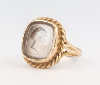 A gold Intaglio cut hard stone set ring, 5.7 grams, size M 