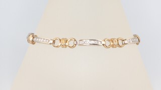 A yellow and white metal 9ct diamond set bracelet, 10.2 grams, 18cm 