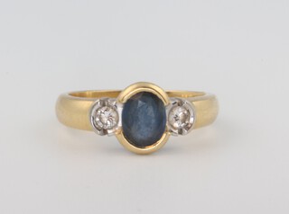 A yellow metal oval sapphire and diamond ring, the centre stone approx 0.75ct, the 2 diamonds each approx. 0.05ct, 4.9 grams, size K 