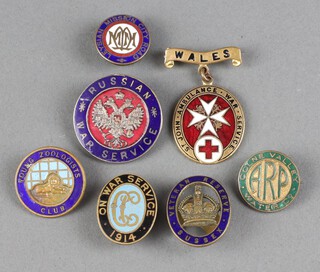 A First World War enamelled Russian War service badge, a Sussex Veteran Reserve badge, a Colne Valley Water Company ARP badge, a 1914 On War Service enamelled badge, 2 other enamelled badges and a John Ambulance Wales enamelled badge