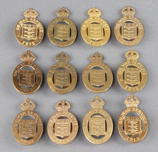 Twelve First World War brass On War Service 1915 lapel badges  