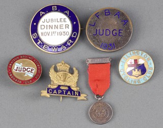 A 1930 Amateur Boxing Association Jubilee Dinner Steward's badge, a L.F.B.AA badge marked Judge 1931, an Amateur Boxing Association gilt metal and enamelled judges badge, an Islington Cycling Club enamelled badge, an enamelled cycling badge marked Captain and an Amateur Athletics Association miniature medal  