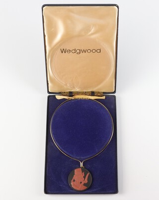 A modern Wedgwood black and brown basalt Egyptianesque pendant on a gilt necklet 