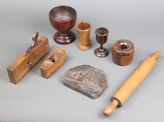 A 19th Century turned lignum vitae stable block 8cm, a turned wooden challis 12cm, ditto bowl 14cm and other items of treen 