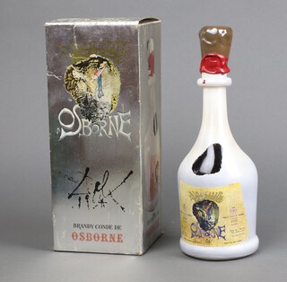 A Salvador Dali design pottery decanter Brandy Conde de Osborne, 75cl, wax sealed, 29cm high, boxed and 