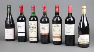 A bottle of 1999 Porte du Roy Saint Emilion Grand Cru red wine, a bottle of 1978 Chateau Chasse-Spleen, a bottle of 2016 Chateau Roc de Segur Bordeaux, a bottle of 1999 Domaine de Saint Paul Chateauneuf du Pape, a bottle of 2007 Chateau Cissac Cru Bourgeois Haute-Medoc, a bottle of 2002 Chateau Touron Merlet Bordeaux, and a bottle of Blason de Bourgogne burgundy, 