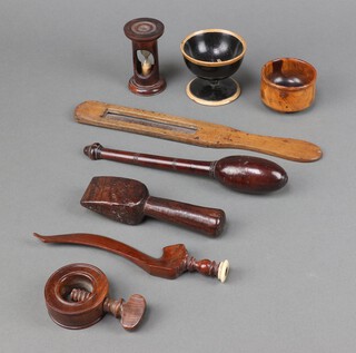 A Lignum Vitae seam rubber, a circular turned wooden bowl 7cm x 7cm, a ditto nut cracker 5cm and various wooden items 