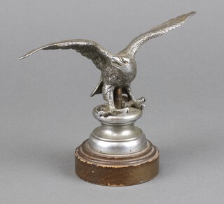 A car mascot in the form of an eagle with outstretched wings on a circular base 13cm x 17cm 