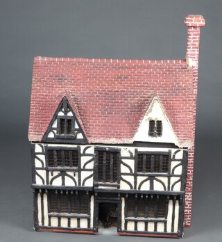 A Geoffrey and Margaret West dolls house (The Tudor House Model dated underneath 1975) made up of 5 main rooms fitted with furniture, accessories, cupboards, etc, plus 2 rooms in the loft space 24cm h x 64cm w x 39cm d 