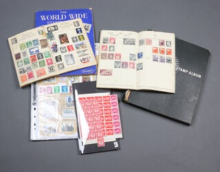 A Universal album of GB and world stamps including India, Canada, 1 other of used world stamps, 3 small paper albums and a ring bound album of world stamps 