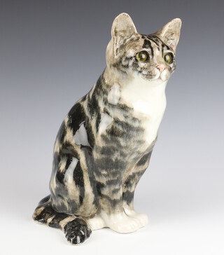 A large Jenny Winstanley glazed figure of a seated cat with glass eyes, painted signature and no. 7, 32cm 