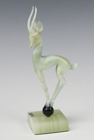 Istvan Komaromy, a glass lamp work figure of a deer with mottle green green decoration standing on a black onyx square base with original torn label 22cm 