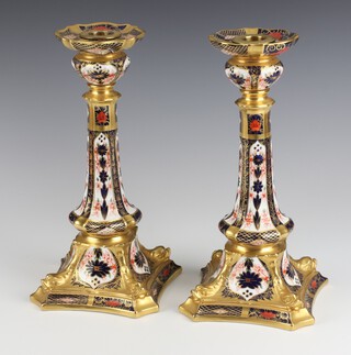 A pair of Royal Crown Derby Imari pattern candlesticks, the bases marked 1128 XXXVI 27cm h (both sconces f and r) 