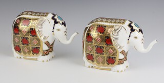 Two Royal Crown Derby  paperweights in the form of standing elephants with gold stoppers LIV and LXI 10cm