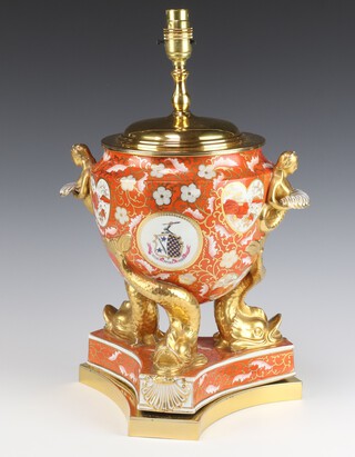 A large and impressive Rockingham style table lamp with armorial decoration and dolphin supports, raised on a triform base 30cm h x 25cm diam. 