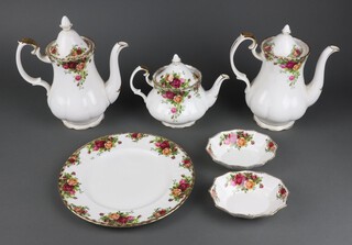 A 34 piece Royal Albert Old Country Rose pattern dinner/tea service comprising 2 coffee pots and a teapot,  2 rectangular twin handled bread plates (1 cracked), 4 crescent shaped saucers incorporating plates, 4 square dishes, 3 circular dishes, pudding bowl (cracked), 2 oval dishes, (all items are seconds), a teapot lid, 12 place mats and 6 coasters 