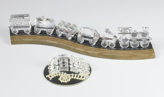 A Swarovski Crystal  locomotive, 1 carriage, 5 tenders and a miniature ditto, boxed together with a wooden track 