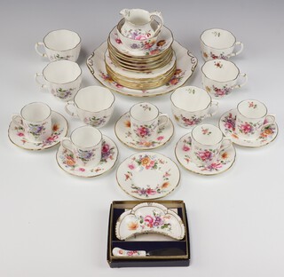 A 33 piece Royal Crown Derby, Derby Posy patterned tea service comprising twin handled bread plate, 6 tea plates, cream jug, sugar bowl, 6 cups and 6 saucers, 5 coffee cans, 6 saucers, crescent shaped butter dish cased 