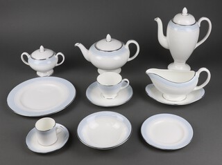 A Wedgwood Mayfair 96 piece tea/dinner service comprising 2 twin handled tureens and covers, twin handled tureen, 2 large oval meat plates, oval meat plate, large platter, oval dish, 8 dinner plates, 8 side plates, 8 tea plates, 8 bowls, 8 twin handled soup bowls and saucers, 2 sauce boats and stands, 8 cups, 7 saucers, tea pot, sugar bowl and cream jug, 2 bread plates, coffee pots, 7 coffee cans, 8 saucers 