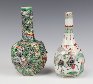 A 19th Century Chinese pierced moulded vase decorated with figures 22cm together with a famille verte bottle vase decorated with figures on horse back,20cm (chipped and cracked) 