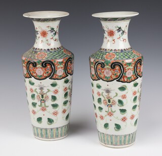 A pair of Chinese 19th Century tapered famille verte vases decorated with formal flowers 36cm