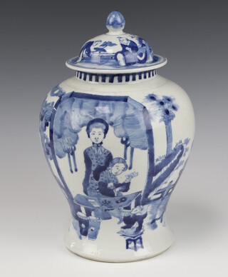 A 19th Century Chinese blue and white baluster vase decorated with figures in a pavilion garden beneath trees with 4 character Kangxi marks to base 32cm 