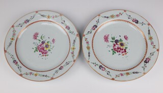 A pair of 18th Century famille rose plates decorated with swags of spring flowers 31cm, both are cracked