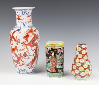 20th Century Chinese vase decorated with dragons, drilled, 32cm, a Chinese black ground cylindrical pot 15cm and a baluster vase decorated with flowers 15cm 