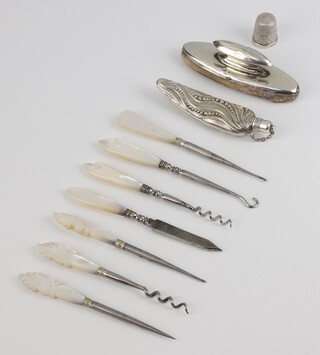 An Edwardian silver nail buffer Birmingham 1909, 7 mother of pearl mounted accessories, scent bottle and thimble 