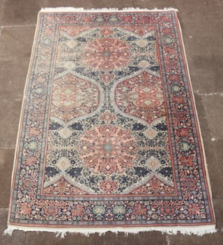 A North Persian white, pink and blue ground rug with stylised medallion to the centre within a multi row border 241cm x 156cm 