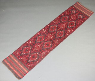 A red and blue ground Meshwani runner with 14 diamonds to the centre 241cm x 55cm 