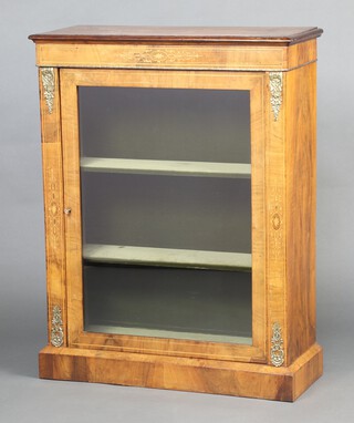 A Victorian inlaid walnut pier cabinet with plush interior fitted shelves and with gilt metal mounts, raised on a platform base 99cm h x 76cm w x 31cm d 